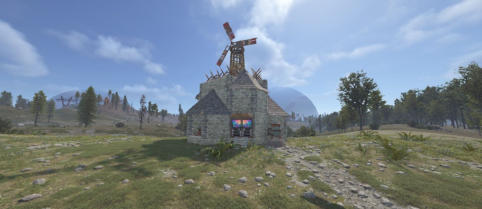 A stone Raidable Base with a windmill on top, standing alone on an open field